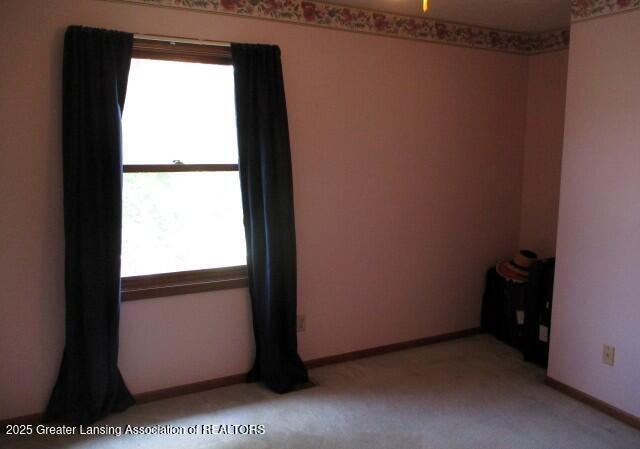 4818 Moultrie Cir, Lansing, MI 48917 - spare room with plenty of natural light and light carpet