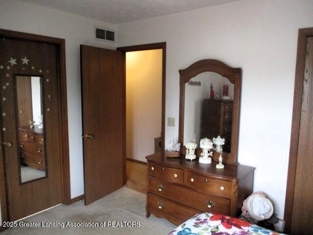 4818 Moultrie Cir, Lansing, MI 48917 - bedroom featuring light colored carpet
