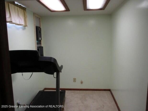4818 Moultrie Cir, Lansing, MI 48917 - workout room with light carpet and baseboards