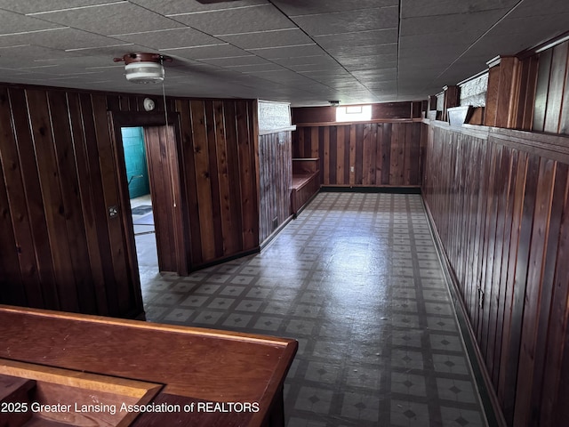 603 Armstrong Rd, Lansing, MI 48911 - basement with tile patterned floors and wood walls