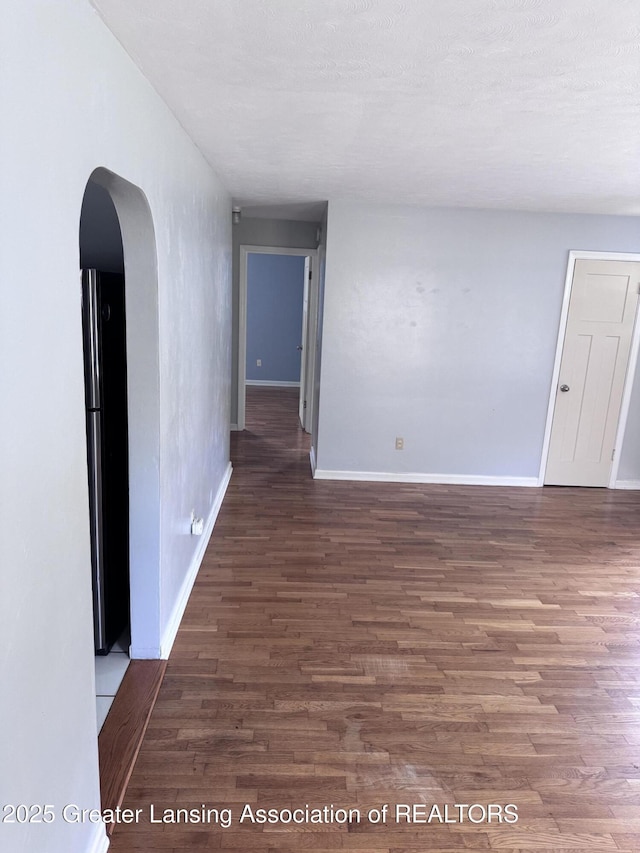 603 Armstrong Rd, Lansing, MI 48911 - spare room with wood finished floors and arched walkways