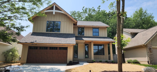 7822 Forestview Dr, Haslett, MI 48840 - view of front of home with board and batten siding, a garage, driveway, and roof with shingles