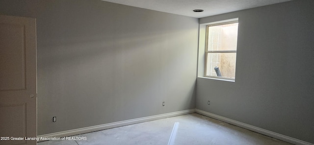7822 Forestview Dr, Haslett, MI 48840 - empty room featuring concrete flooring and baseboards