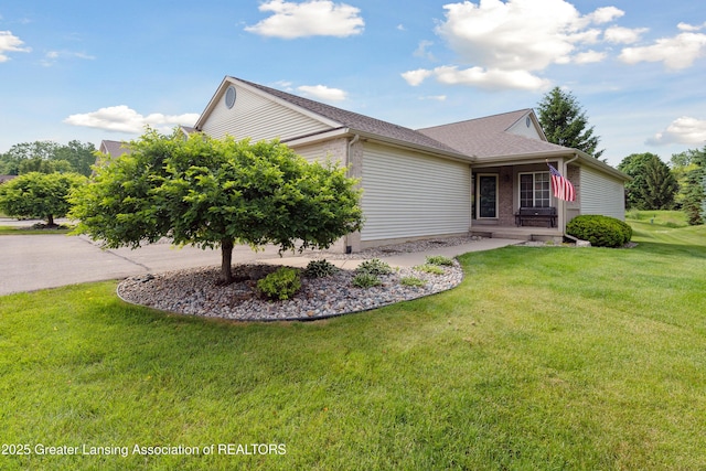 1703 Willow Creek Dr Unit 29, Lansing, MI 48917 - view of front of property featuring a front lawn, driveway, and an attached garage