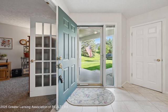 1703 Willow Creek Dr Unit 29, Lansing, MI 48917 - entrance foyer featuring light tile patterned flooring and a textured ceiling