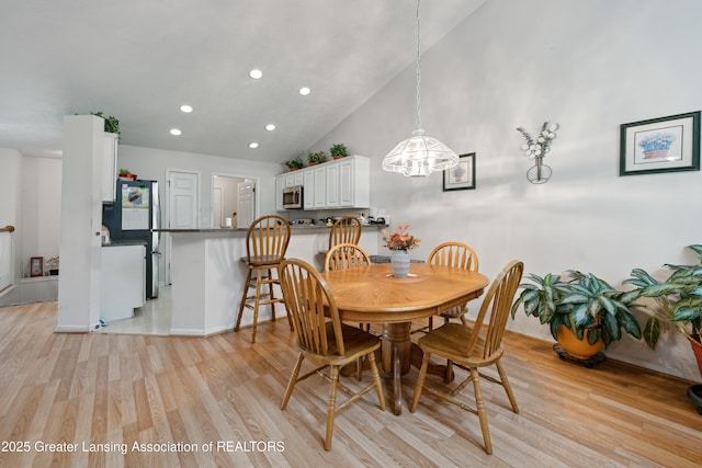 1703 Willow Creek Dr Unit 29, Lansing, MI 48917 - dining area with a chandelier, recessed lighting, light wood finished floors, and lofted ceiling