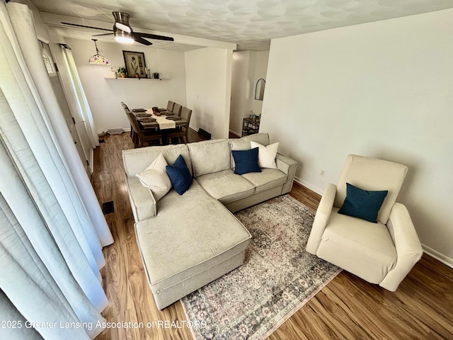 3130 Delta River Dr, Lansing, MI 48906 - living area with wood finished floors, baseboards, and ceiling fan