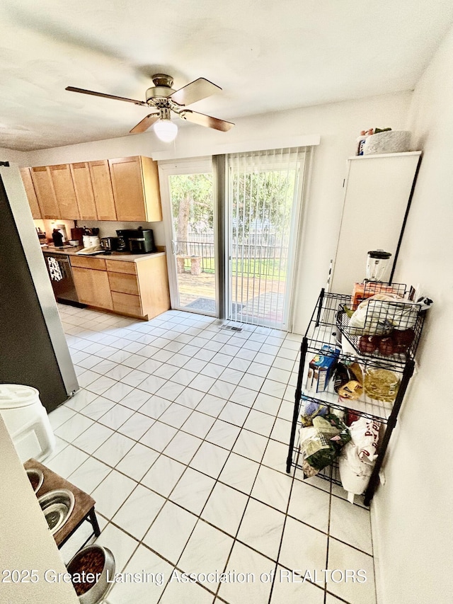 3130 Delta River Dr, Lansing, MI 48906 - kitchen with light brown cabinetry, light tile patterned flooring, and ceiling fan