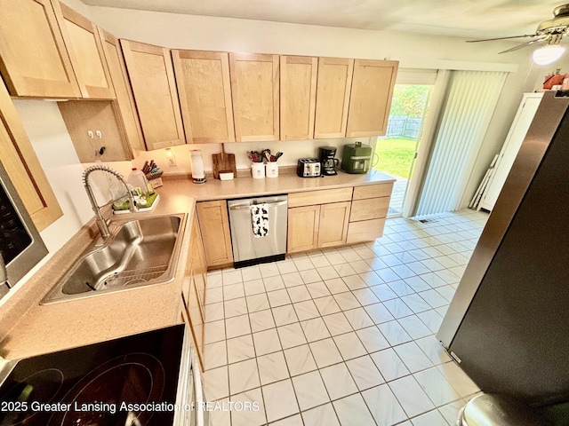 3130 Delta River Dr, Lansing, MI 48906 - kitchen with appliances with stainless steel finishes, light brown cabinetry, a sink, light countertops, and a ceiling fan