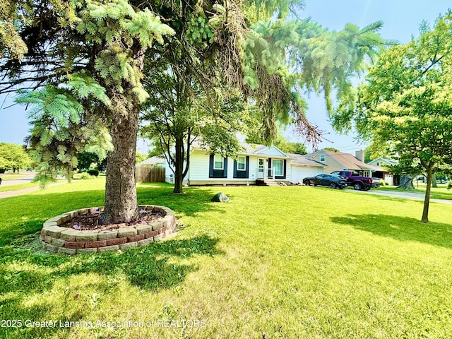 3130 Delta River Dr, Lansing, MI 48906 - view of green lawn with a garage