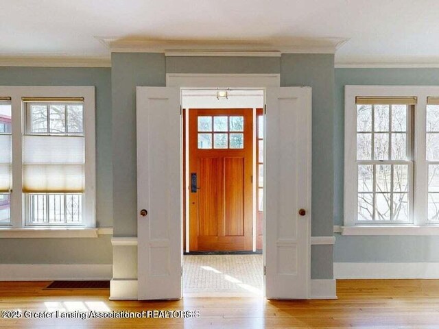 1046 Cresenwood Rd, East Lansing, MI 48823 - foyer with wood finished floors, healthy amount of natural light, and crown molding
