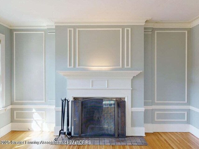 1046 Cresenwood Rd, East Lansing, MI 48823 - detailed view of wood finished floors, a fireplace with flush hearth, and ornamental molding