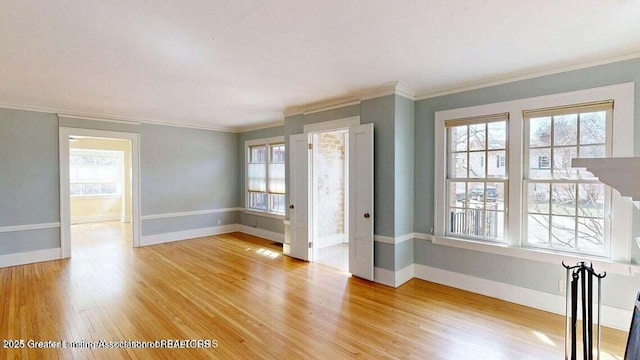 1046 Cresenwood Rd, East Lansing, MI 48823 - spare room featuring ornamental molding, light wood-type flooring, and healthy amount of natural light