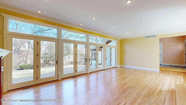 1046 Cresenwood Rd, East Lansing, MI 48823 - spare room featuring ornamental molding, french doors, light wood-style flooring, and recessed lighting
