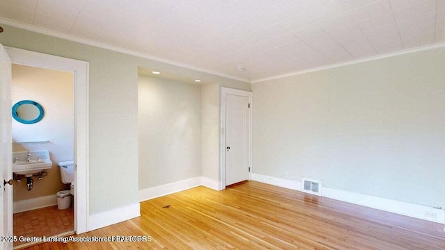 1046 Cresenwood Rd, East Lansing, MI 48823 - unfurnished room featuring ornamental molding and light wood-style floors
