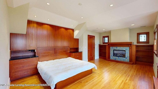 1046 Cresenwood Rd, East Lansing, MI 48823 - bedroom featuring light wood-type flooring, a fireplace, recessed lighting, and a closet