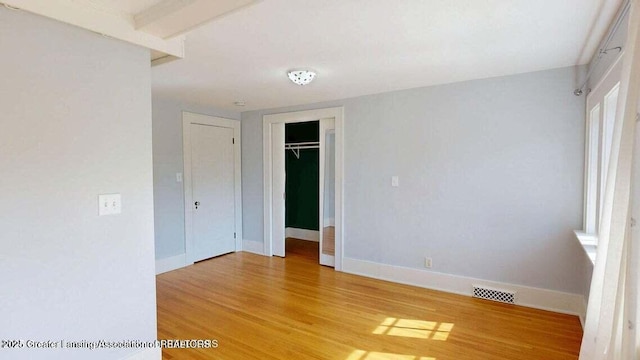 1046 Cresenwood Rd, East Lansing, MI 48823 - unfurnished bedroom featuring light wood-style floors and a closet