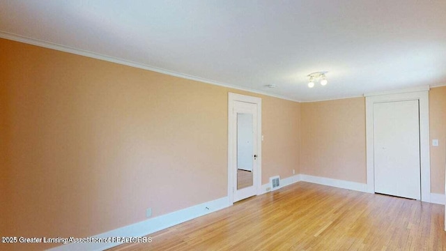 1046 Cresenwood Rd, East Lansing, MI 48823 - empty room with light wood finished floors and ornamental molding