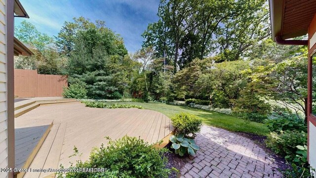 1046 Cresenwood Rd, East Lansing, MI 48823 - view of green lawn with a patio and a wooden deck