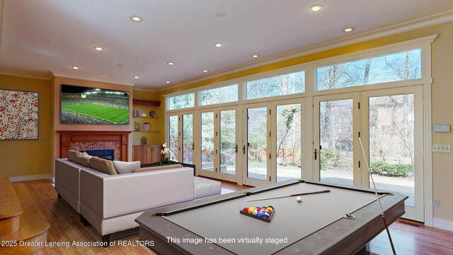 1046 Cresenwood Rd, East Lansing, MI 48823 - game room featuring ornamental molding, a glass covered fireplace, wood finished floors, recessed lighting, and billiards table