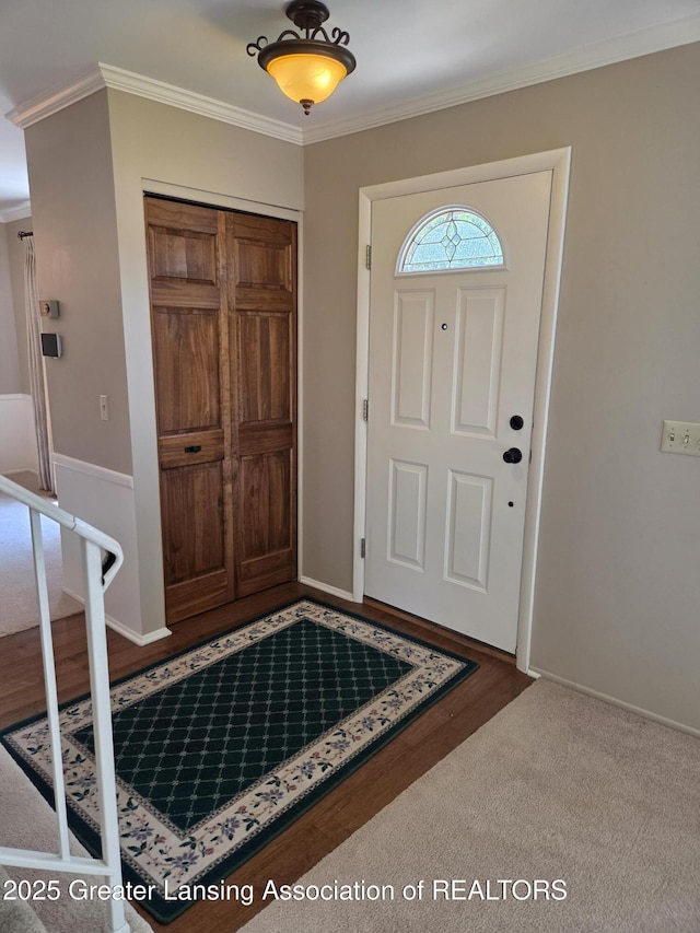 2115 Lyman Dr, Lansing, MI 48912 - entrance foyer featuring crown molding and baseboards