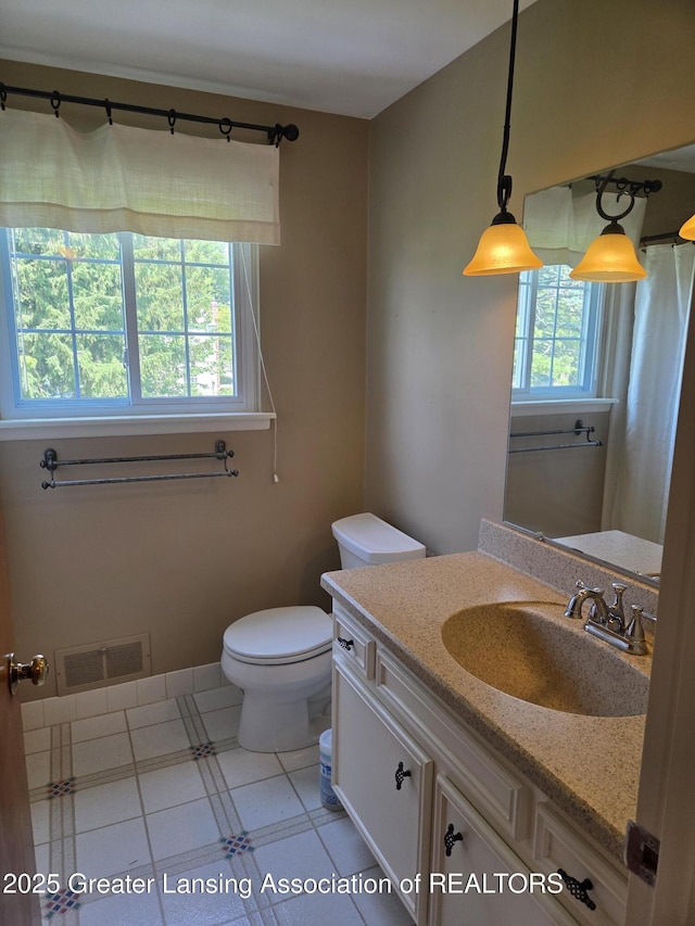 2115 Lyman Dr, Lansing, MI 48912 - bathroom featuring toilet and vanity