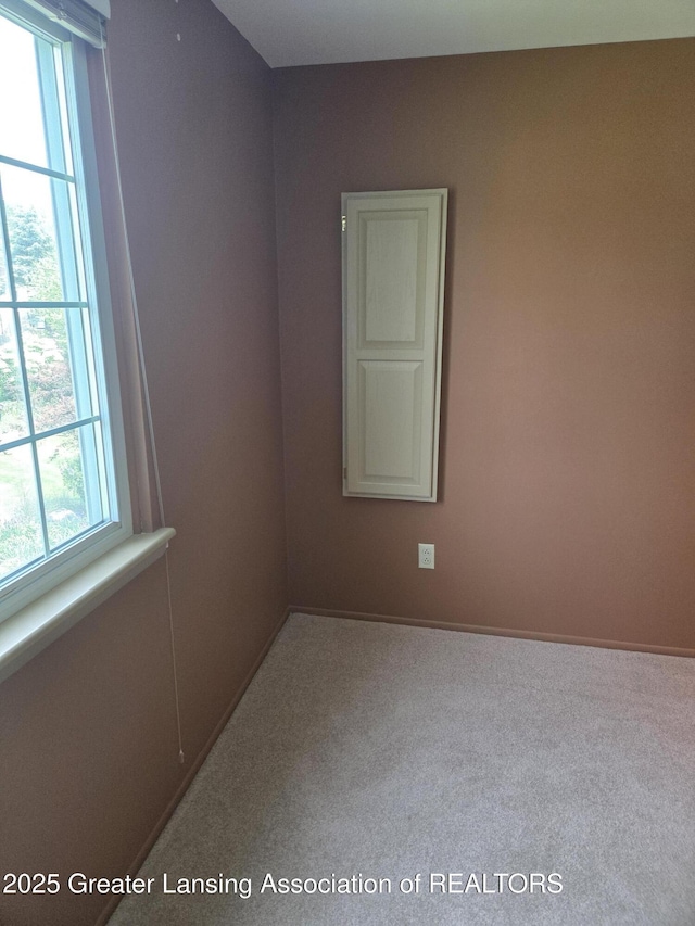2115 Lyman Dr, Lansing, MI 48912 - carpeted empty room featuring baseboards