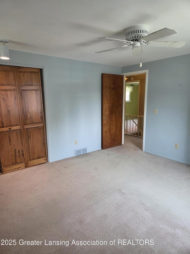 2115 Lyman Dr, Lansing, MI 48912 - unfurnished bedroom with carpet floors, a closet, and ceiling fan