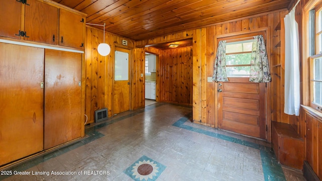 523 N Fairview Ave, Lansing, MI 48912 - foyer entrance featuring wooden ceiling, wooden walls, and tile patterned floors