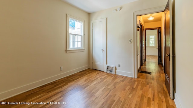 523 N Fairview Ave, Lansing, MI 48912 - unfurnished bedroom featuring light wood finished floors, baseboards, and a closet