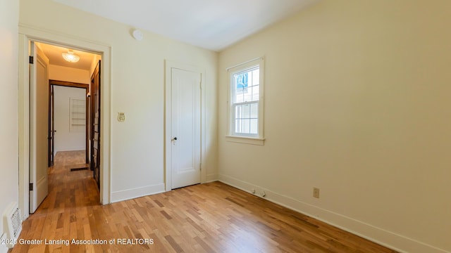 523 N Fairview Ave, Lansing, MI 48912 - unfurnished bedroom featuring light wood finished floors, baseboards, and a closet