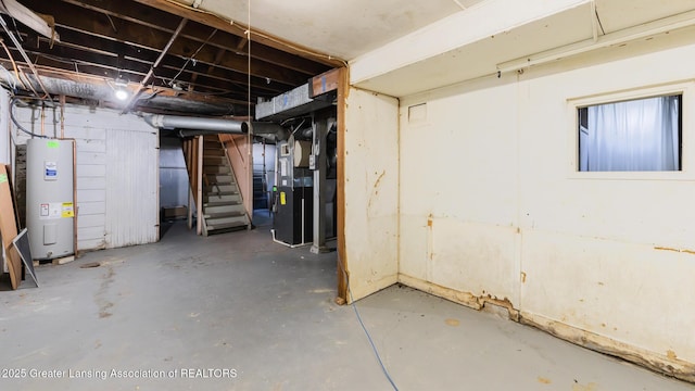 523 N Fairview Ave, Lansing, MI 48912 - unfinished below grade area with electric water heater, stairs, and heating unit