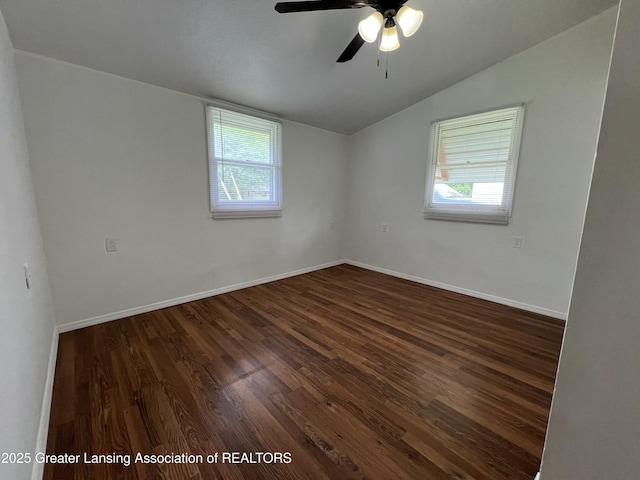 4219 Richmond St, Lansing, MI 48911 - spare room with vaulted ceiling, healthy amount of natural light, dark wood-style flooring, ceiling fan, and baseboards