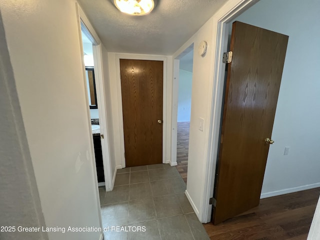4219 Richmond St, Lansing, MI 48911 - hall with a textured ceiling, baseboards, and tile patterned flooring