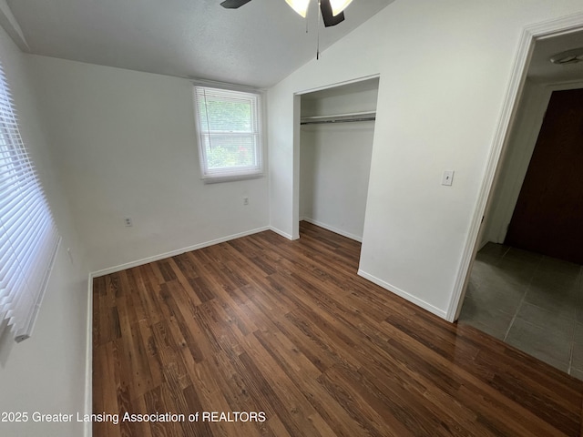 4219 Richmond St, Lansing, MI 48911 - unfurnished bedroom with lofted ceiling, a closet, dark wood-type flooring, baseboards, and ceiling fan