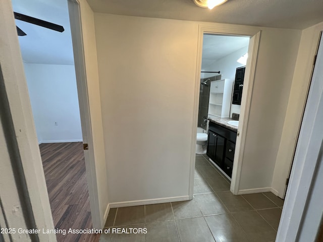 4219 Richmond St, Lansing, MI 48911 - bathroom featuring vanity, toilet, tile patterned flooring, baseboards, and ceiling fan
