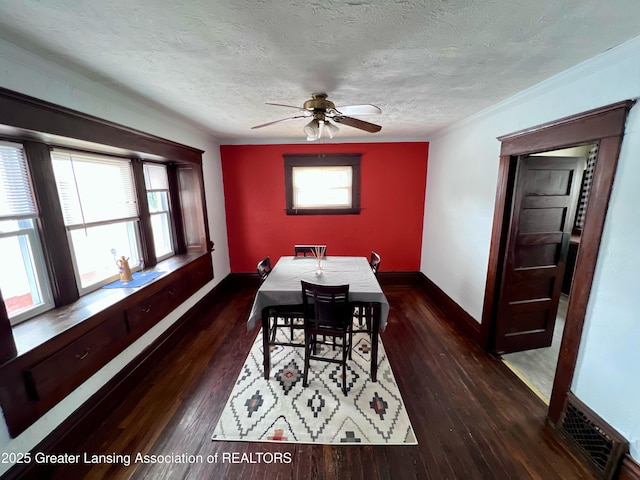 1403 W Michigan Ave, Lansing, MI 48915 - dining room featuring plenty of natural light, ceiling fan, baseboards, dark wood-style floors, and a textured ceiling