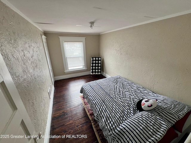 1403 W Michigan Ave, Lansing, MI 48915 - bedroom with a textured wall, wood finished floors, crown molding, and baseboards
