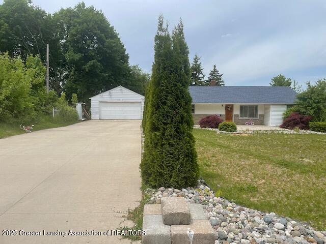 4022 Stabler St, Lansing, MI 48910 - view of front of house with an outbuilding, a garage, a front lawn, and a chimney