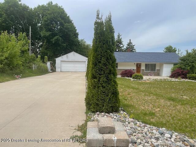 4022 Stabler St, Lansing, MI 48910 - view of front of property with an outdoor structure, a garage, and a front yard