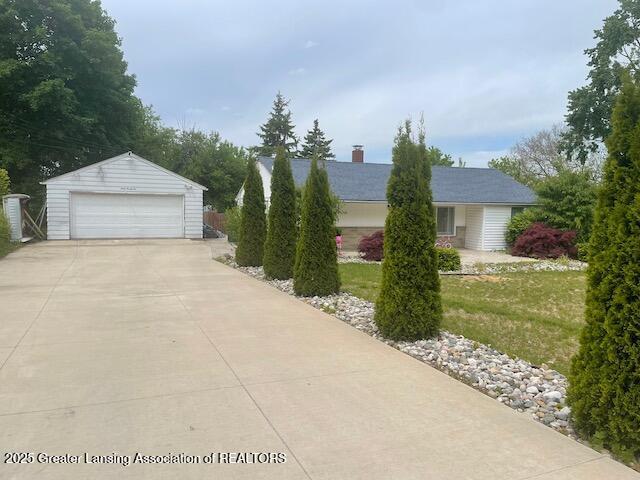4022 Stabler St, Lansing, MI 48910 - view of front of house with a garage, an outbuilding, and a front yard