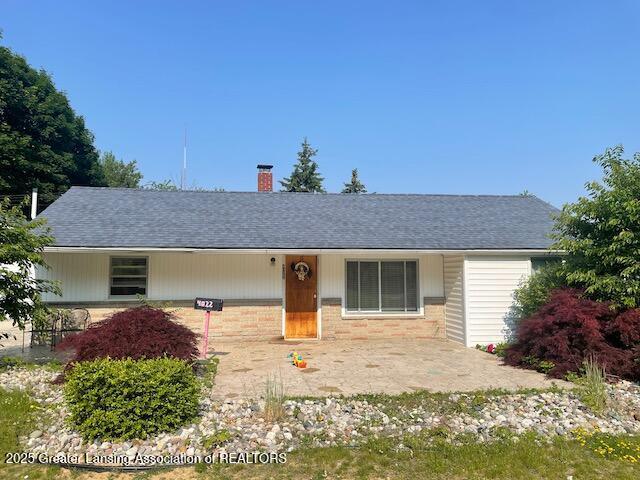 4022 Stabler St, Lansing, MI 48910 - ranch-style home featuring a chimney, brick siding, and roof with shingles
