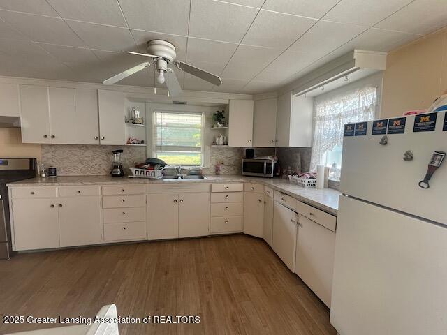 4022 Stabler St, Lansing, MI 48910 - kitchen featuring freestanding refrigerator, open shelves, range, light countertops, and a ceiling fan