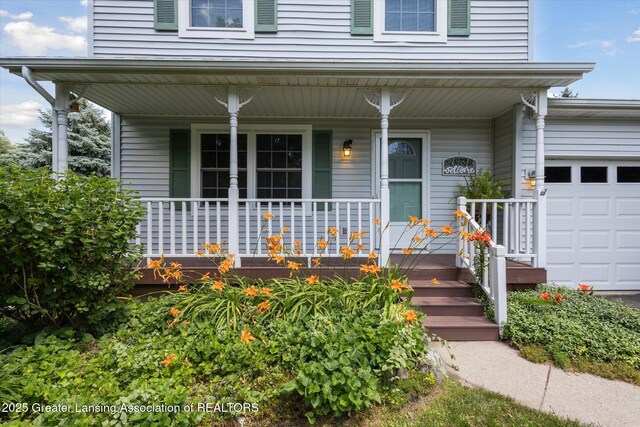 202 Kerry St, Eaton Rapids, MI 48827 - entrance to property featuring a porch and an attached garage
