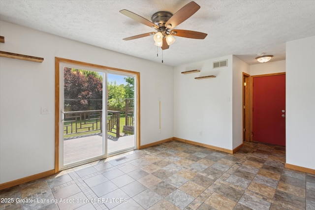 202 Kerry St, Eaton Rapids, MI 48827 - empty room with ceiling fan, a textured ceiling, and stone finish flooring