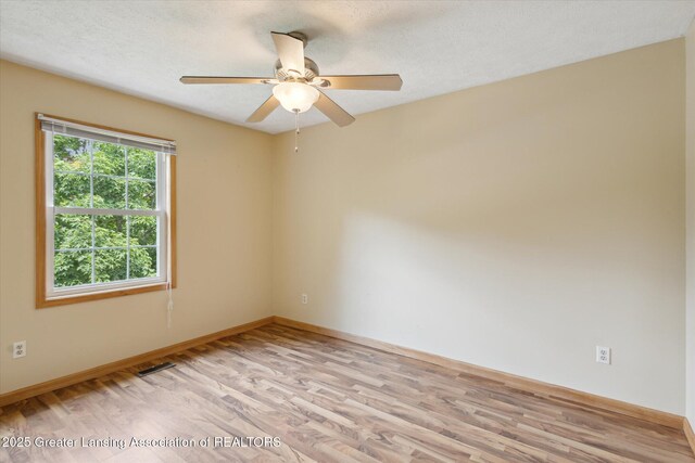 202 Kerry St, Eaton Rapids, MI 48827 - empty room with light wood finished floors and ceiling fan