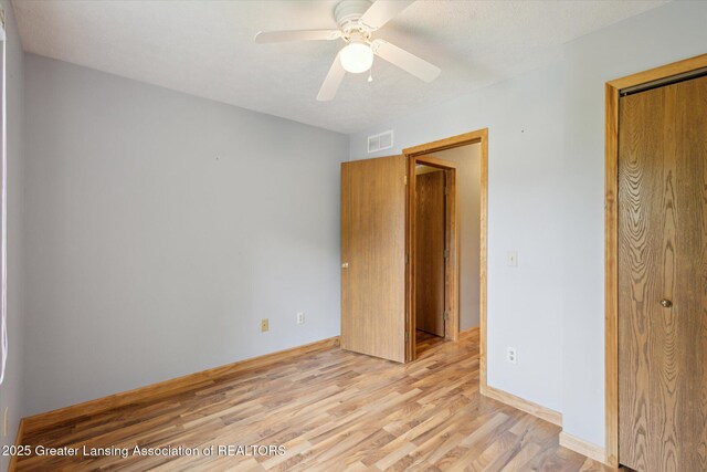 202 Kerry St, Eaton Rapids, MI 48827 - unfurnished bedroom featuring light wood-style floors, a closet, and ceiling fan