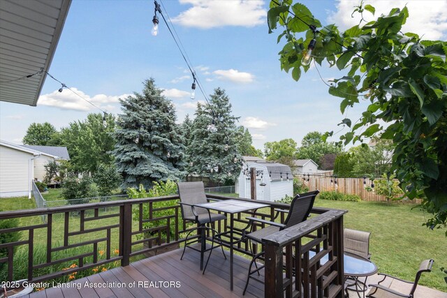 202 Kerry St, Eaton Rapids, MI 48827 - wooden deck featuring a shed, outdoor dining space, and a fenced backyard