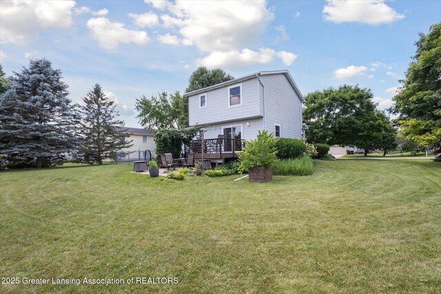 202 Kerry St, Eaton Rapids, MI 48827 - rear view of property with a deck and a yard