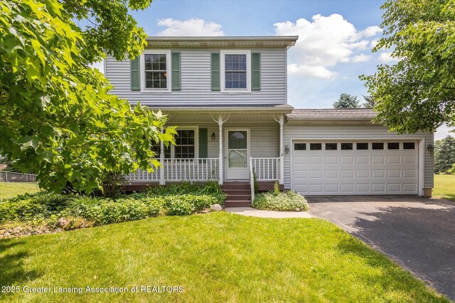 202 Kerry St, Eaton Rapids, MI 48827 - traditional-style house featuring driveway, a porch, a front lawn, and an attached garage